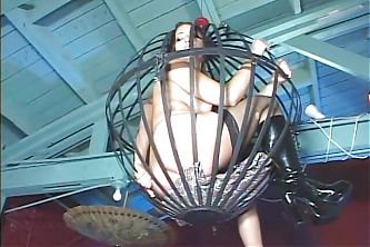 Sex blonde and brunette slaves suck big cock while locked in their cage